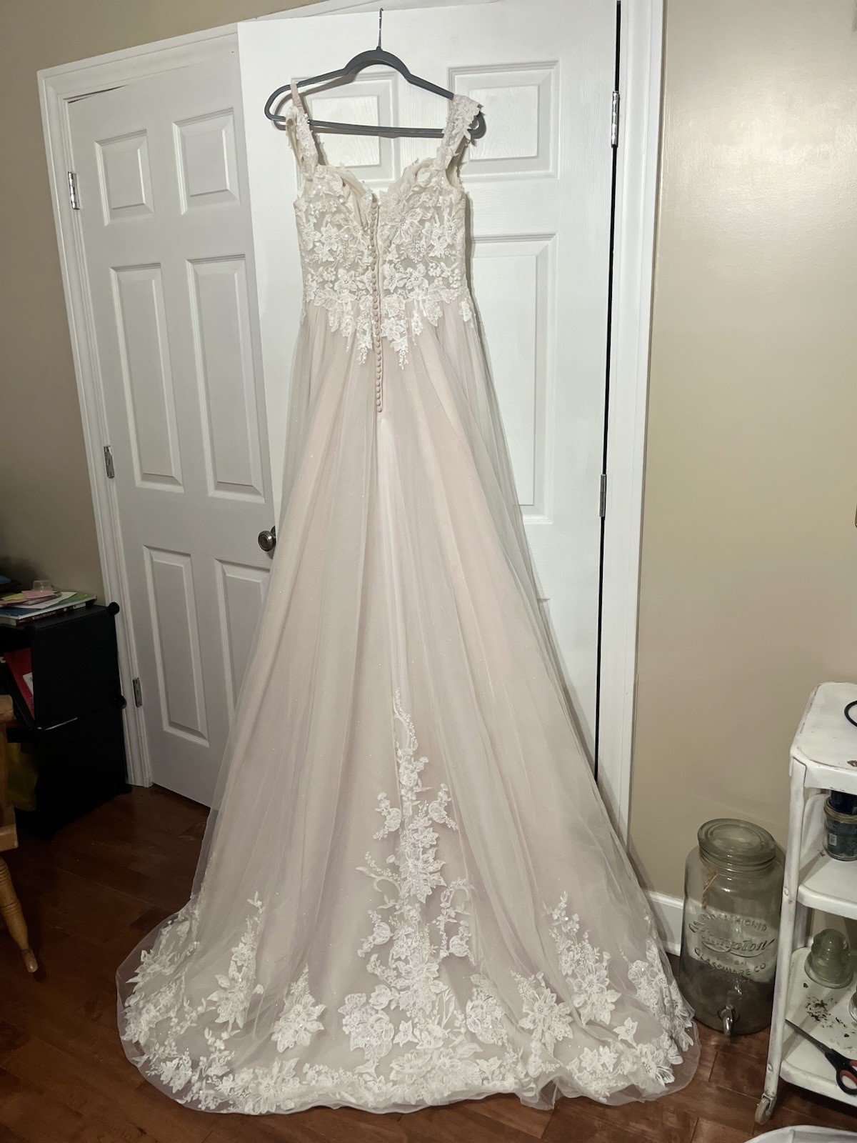 A contemporary white lace and tulle wedding dress with V-neck. Brand New Size 12