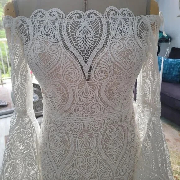 Mermaid wedding dress with bell sleeves and crochet lace off the Shoulder