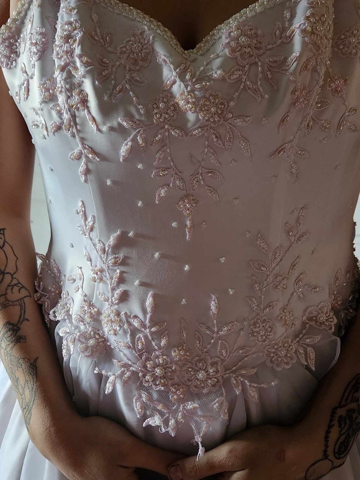 wedding dress believed to be size 4, white with very light pink beading at top