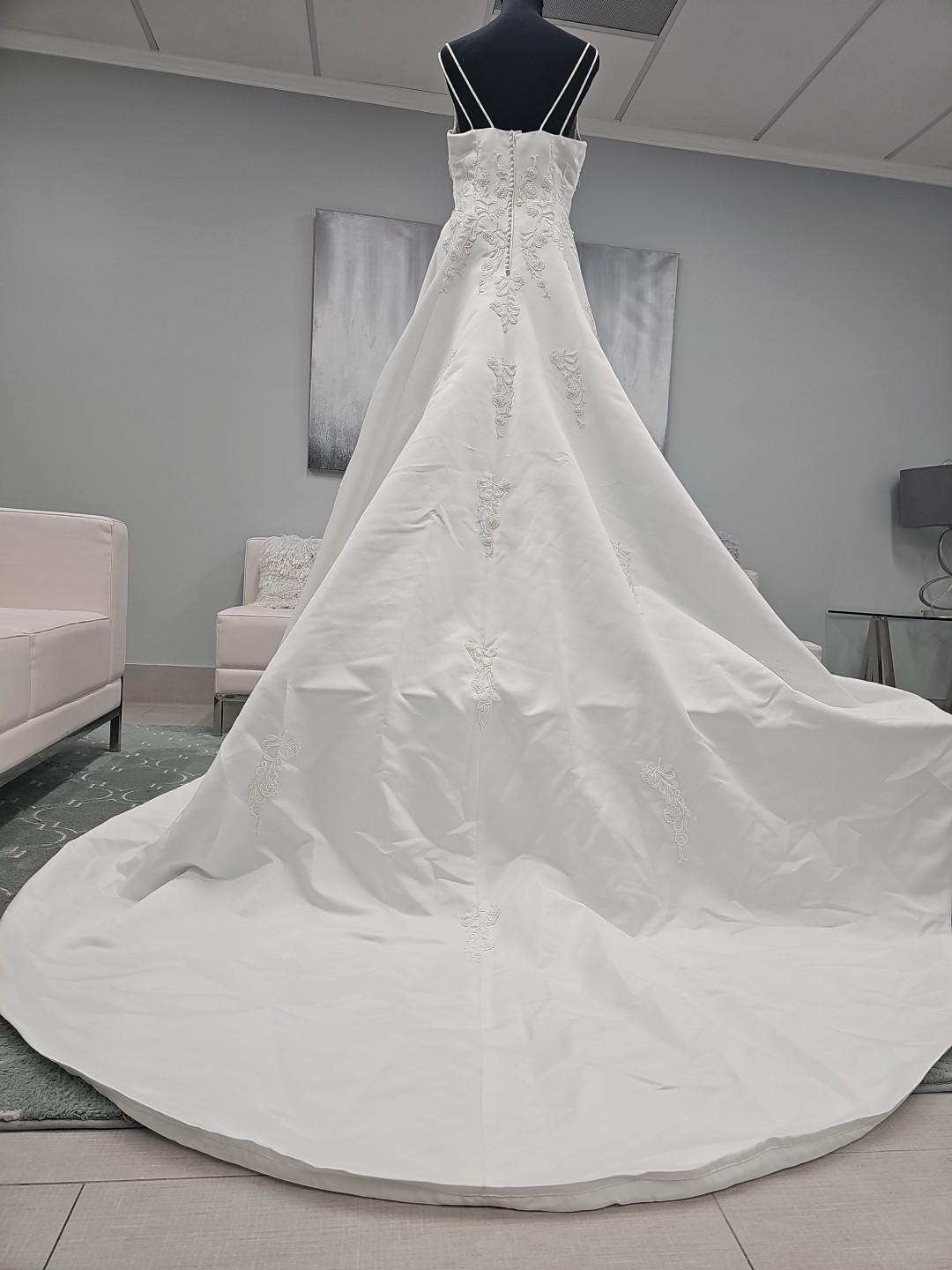 B8963 is a white Satin a-line Gown Adorn with venice Cascading from top to waist